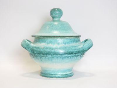 a blue and white bowl with a lid on a white surface