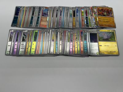 the collection of pokemon cards are sitting on the table