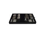 a black tray with a pair of scissors and a pair of scissors in it