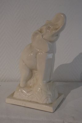 a white statue of a woman holding a baby