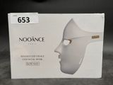 a white box with a white face mask on it