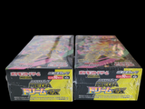 two boxes of pokemon trading cards on a black background