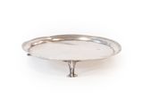 a silver plate on a stand on a white background
