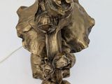 a statue of an elephant with a flower on it ' s head