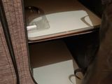 a suitcase that is open on the floor next to a chair