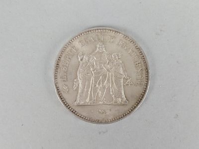 a close up of a coin on a white surface with a white background