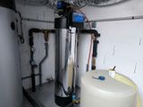 a tank with a water heater in the corner of a room