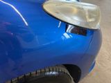 a close up of a car ' s headlight on a blue car