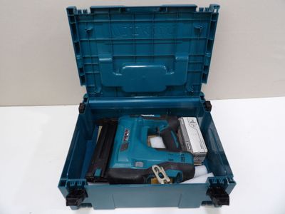 a blue tool box with a hammer and a nail brush in it
