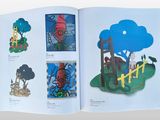 an open book with a picture of a tree and a house