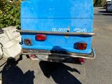 a blue truck that is parked in the parking lot