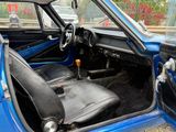 a blue car with black leather seats and a steering wheel