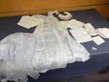 a table with a table cloth and a wedding dress on it