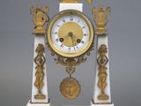 a white and gold clock with an eagle on top of it