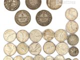 a group of old coins on a white surface with a white background