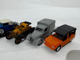 several toy cars are lined up in a row on a white surface