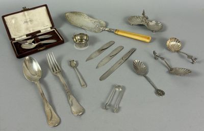 a lot of silverware on a table with a case