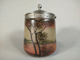 a glass jar with a picture of a tree on it