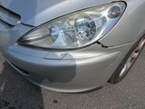 a close up of a car ' s headlight on the street