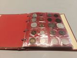 a red book with a bunch of coins inside of it