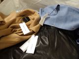 a pile of clothes and a pair of scissors on a bed