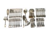 a lot of silver spoons and forks on the table