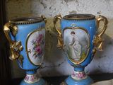 two vases sitting on a table next to a bowl