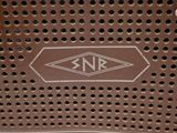 a close up of a metal grate with a logo on it