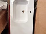 a white sink and a brown chair in a room