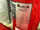 a red fire extinguisor sitting next to other red fire extinguisors
