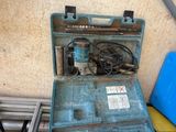 a blue tool case with tools in it on a table