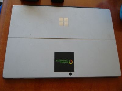 a laptop computer sitting on top of a wooden table