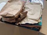 a cardboard box full of clothes on a table in a room