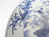 a blue and white plate with a flower design on it