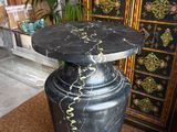 a black vase sitting on top of a rug in a room