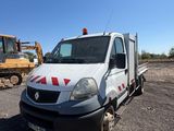 a white truck that is parked next to a bulldozer