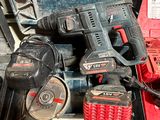 the tools are sitting in the case on the floor next to the tool box