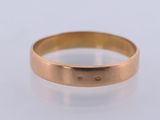 a close up of a gold ring on a white surface