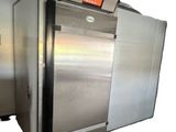 two stainless steel ovens sitting side by side on a white background