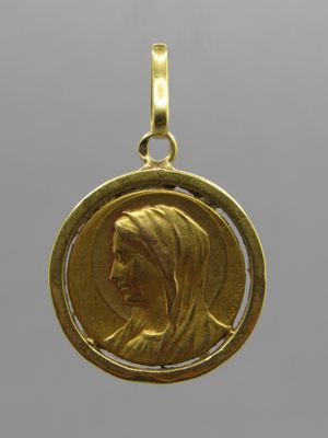 a close up of a gold coin with a woman ' s face on it