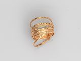 a close up of a gold ring on a white surface