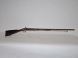 a rifle on a table with a white background
