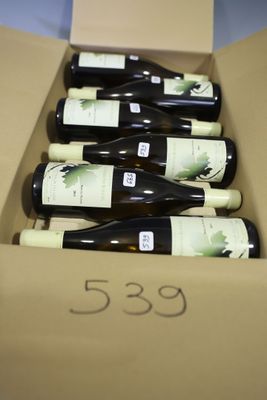 six bottles of wine in a cardboard box with a price tag