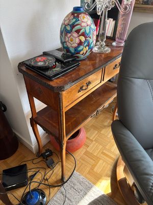 a table with a vase on top of it next to a chair