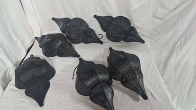 six black leather birds on a white sheet with a white background