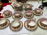 a lot of cups and saucers on a table