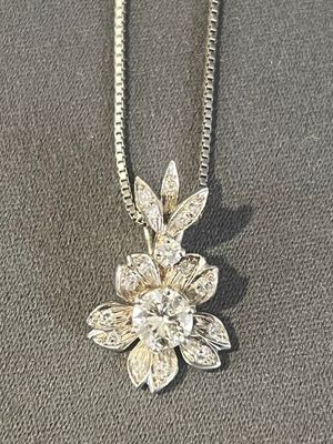 silver plated necklace with a flower pendant and a chain
