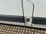 a close up of a door handle on a white van
