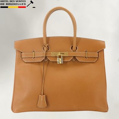 a brown leather handbag on a white background