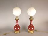 pair of red and gold table lamps with white glass shades
